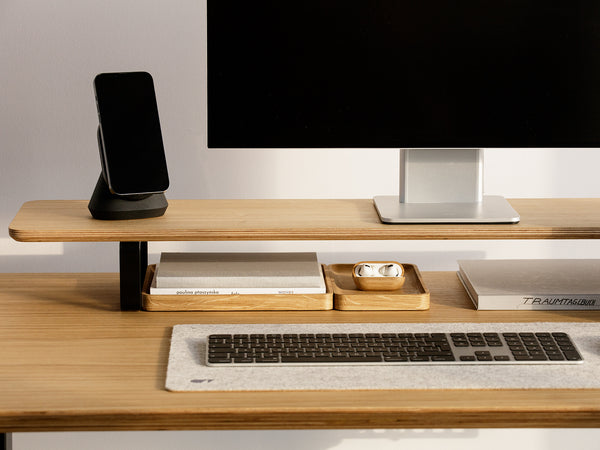 black magsafe iphone stand with iphone on a veneer desk shelf | black